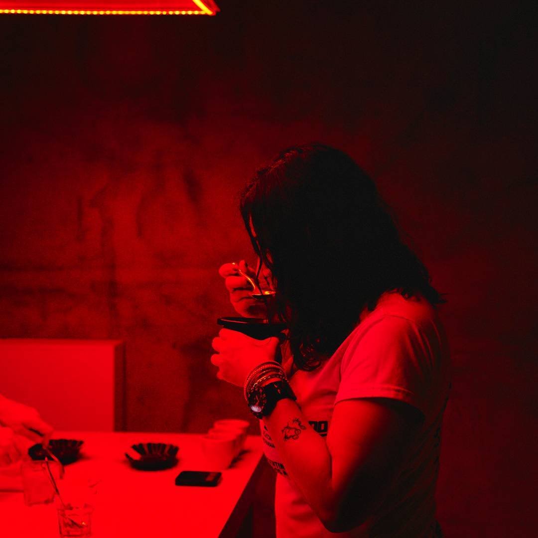a woman cupping coffee in a red lab